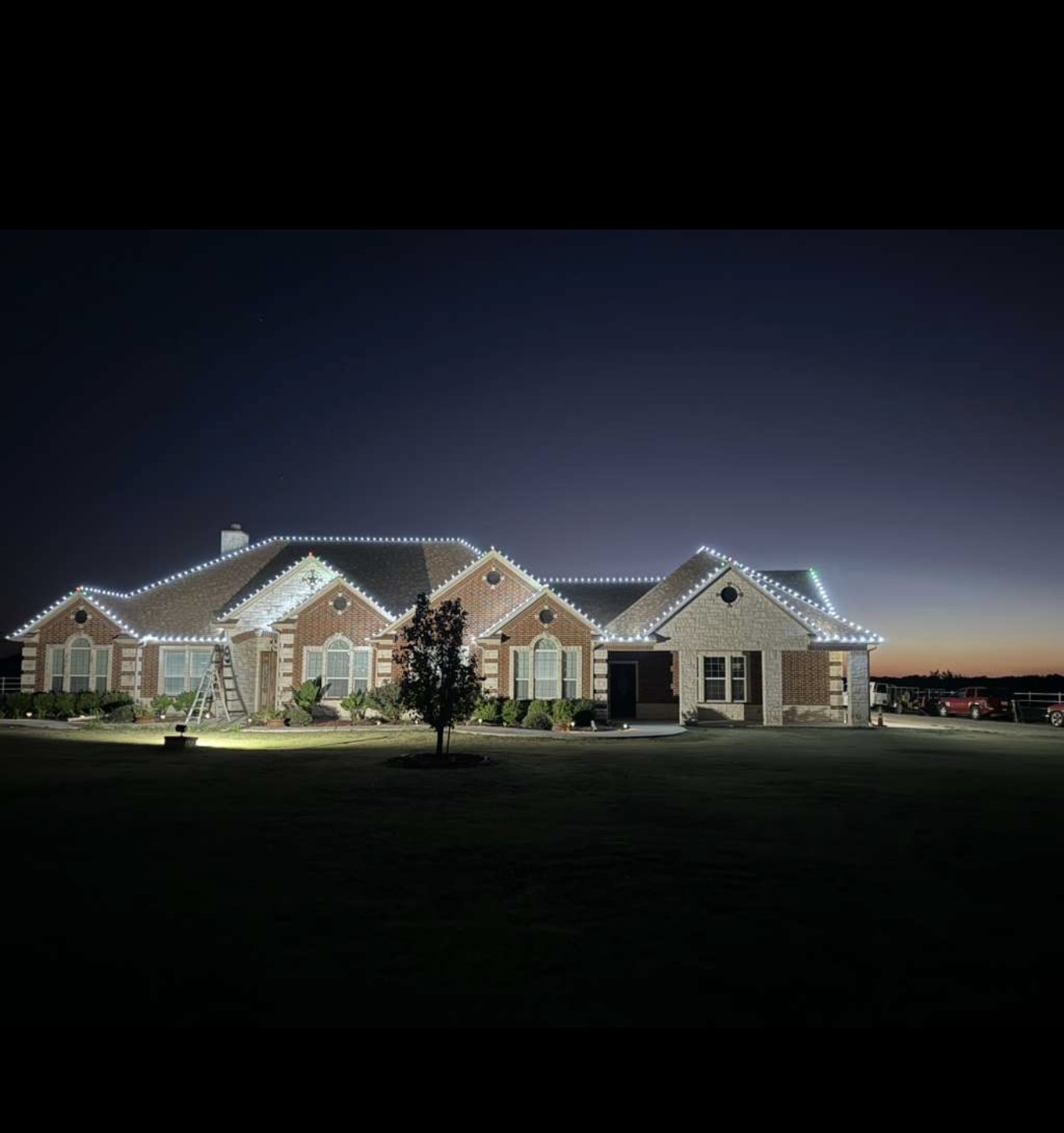 White Christmas roofline lights on a large residential property