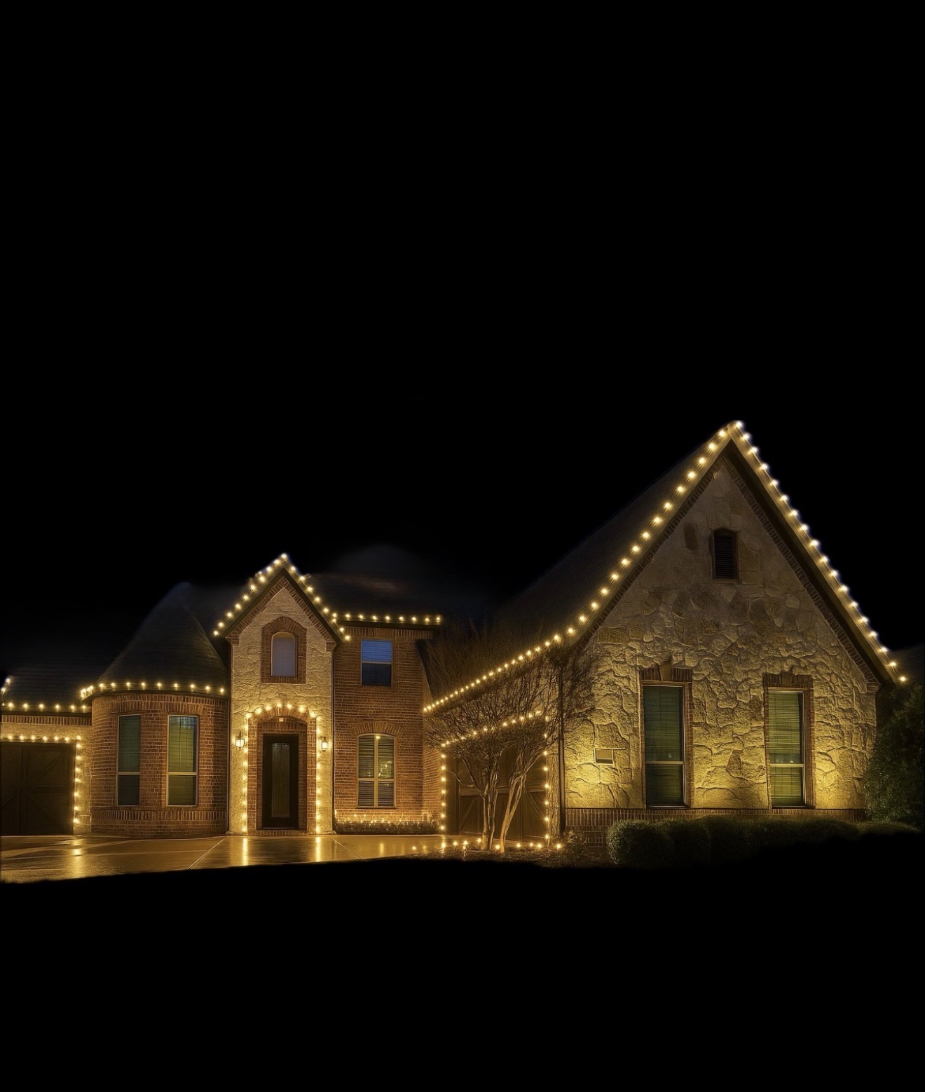 Warm white Christmas light installation on a stone and brick home